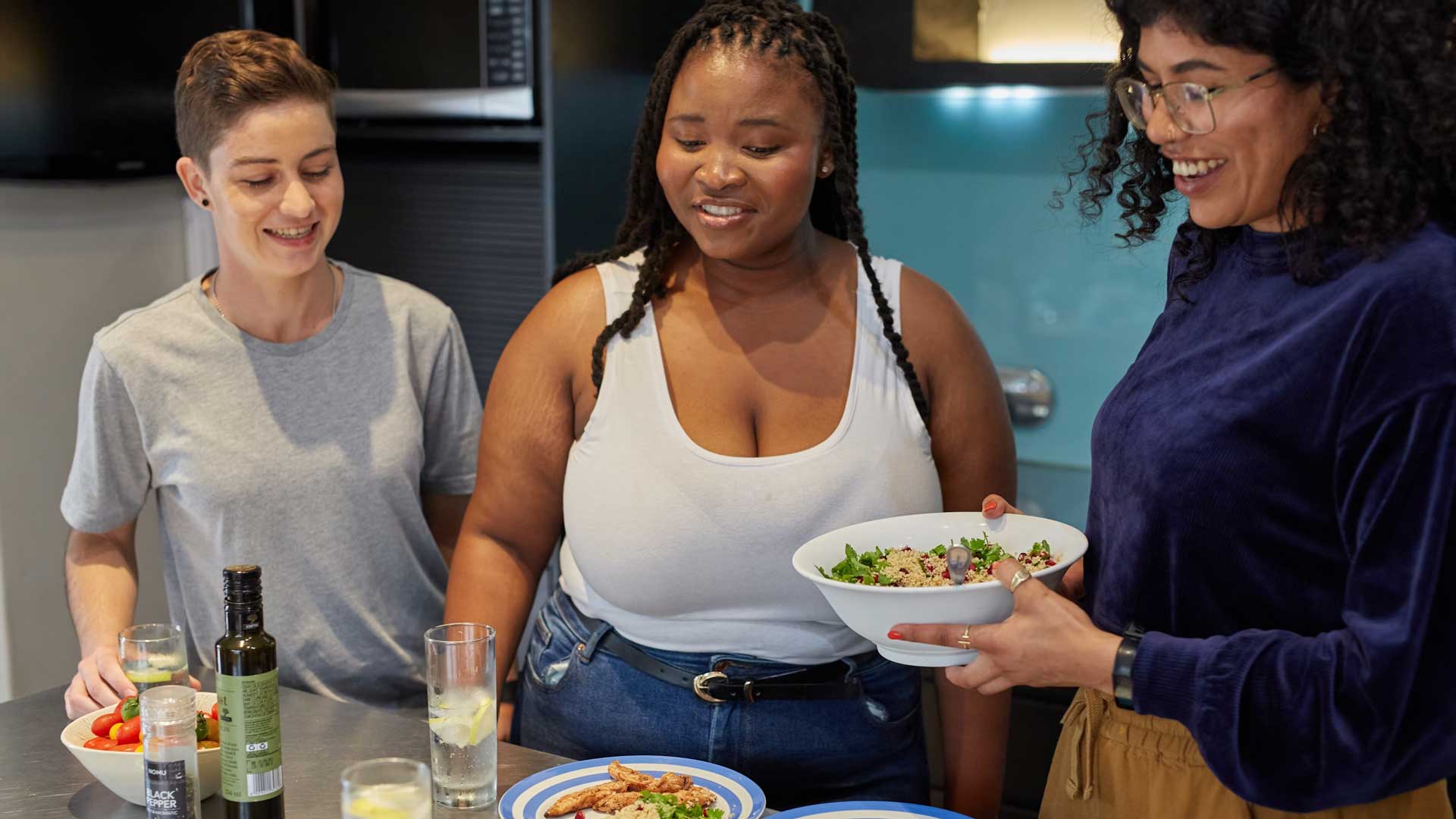 Students plating up food in their accommodation