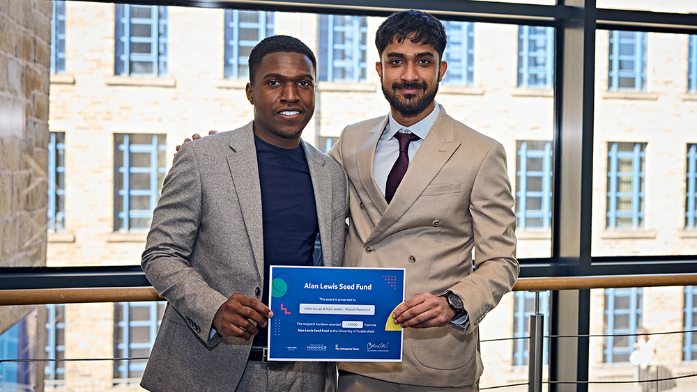 An image of two men holding a certificate