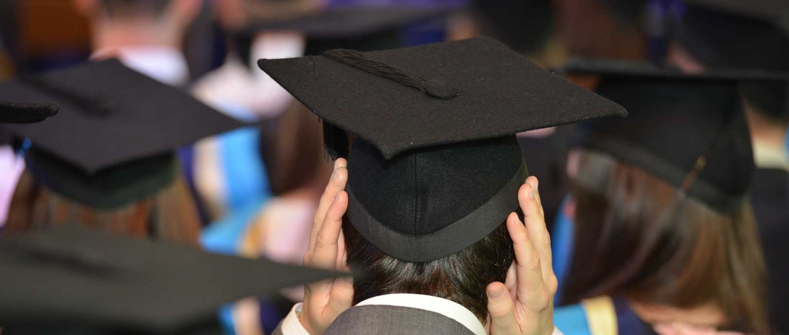 Back of a graduates head with cap and gown on in St Paul's 